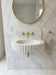 Marble sink with gold fixtures in a bathroom setting. Carrara White Marble Wall-mount Bathroom Sink Fluted Front (W)16" (L)24" (H)6"