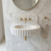 Marble sink with gold fixtures in a bathroom setting. Carrara White Marble Wall-mount Bathroom Sink Fluted Front (W)16" (L)24" (H)6"