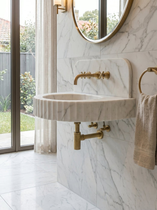 Bathroom with marble sink and gold fixtures. Carrara White Marble Wall-mount Bathroom Sink Fluted Front (W)16" (L)24" (H)6"