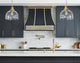 Curve Black Range Hood with Brass Rivets and Pot Rack
