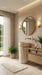 Modern bathroom with a round mirror, sink, and plants.