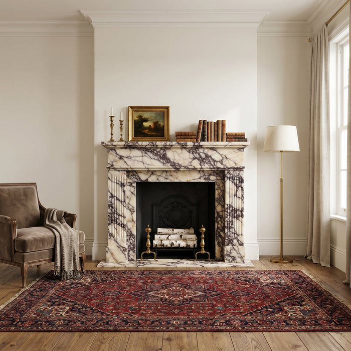 Living room with marble fireplace, armchair, and patterned rug.