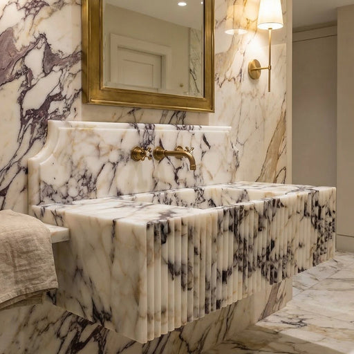 Marble bathroom vanity with gold fixtures and mirror