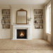 Living room with a fireplace, bookshelves, and a large mirror.