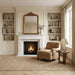 Cozy living room with fireplace, armchair, and bookshelves.