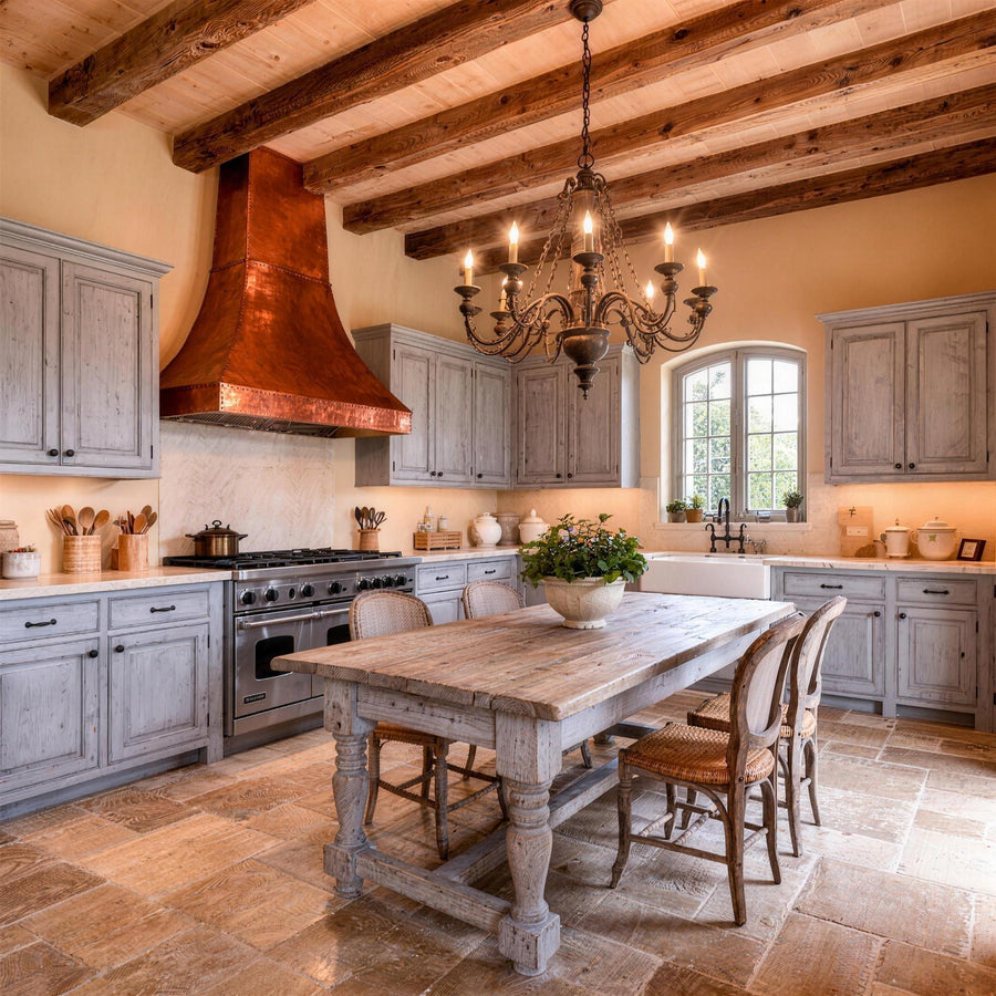 French country farmhouse kitchen with copper range hood and wooden beams