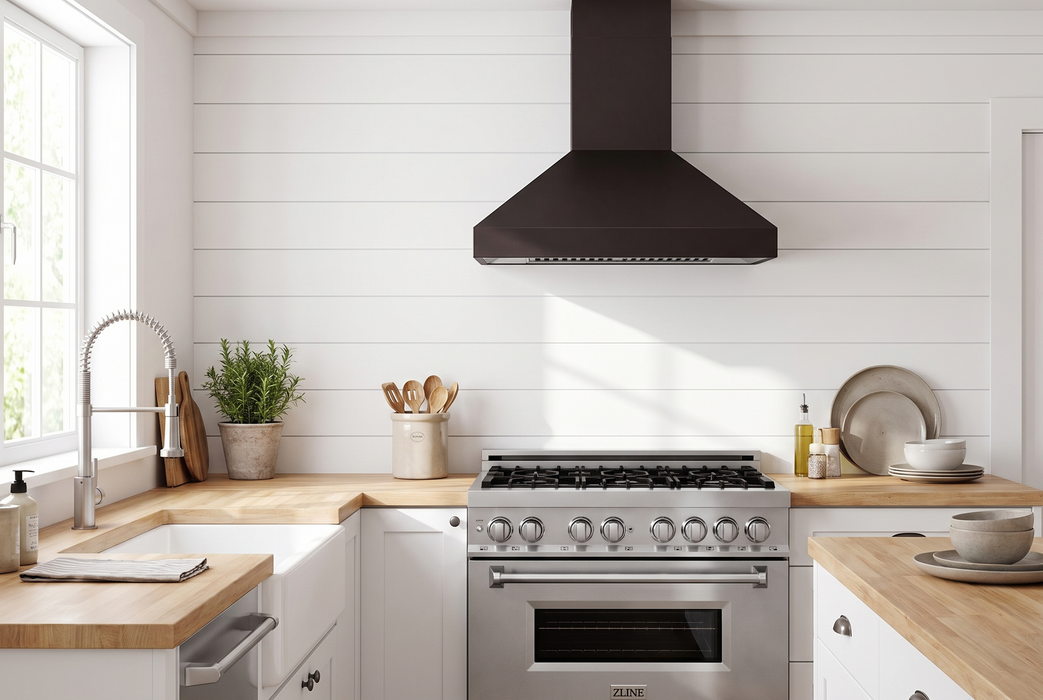 ZLINE 36-inch bronze statement kitchen set staged: RA36 stainless range, 8667B-36 oil-rubbed bronze wall hood, Apollo faucet